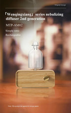 Essential oil diffuser with clear glass bottle and light wood base, brass knob and side profile