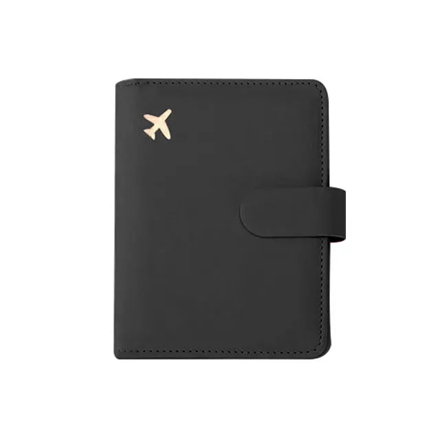 Black passport folio with gold airplane emblem and wrap-around strap closure