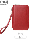 Cardinal red RFID passport sleeve with wrist strap and top zipper; minimalist embossed emblem