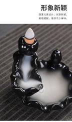 Tower backflow incense burner front view with black glossy figure and cone