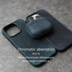 Dark blue leather AirPods case with open face and side port cutouts