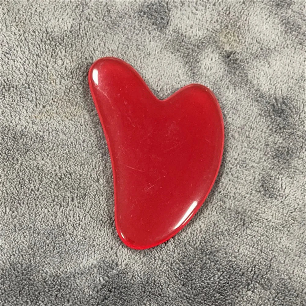 Garnet red gua sha stone with glossy deep red, curved teardrop shape.