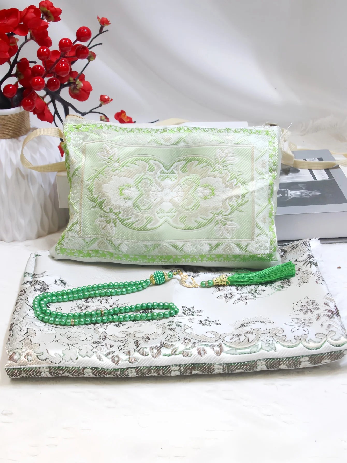 Prayer rug gift set with green embroidered pouch, white patterned mat, and green bead tassels