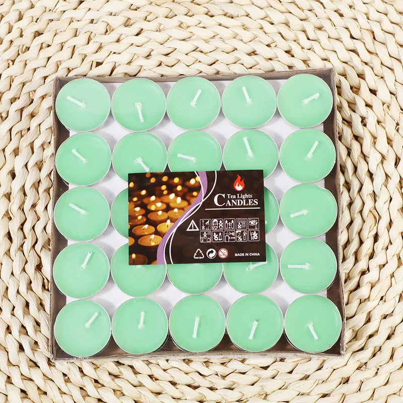 Green tea light candles in a tray, each with a white wick tip