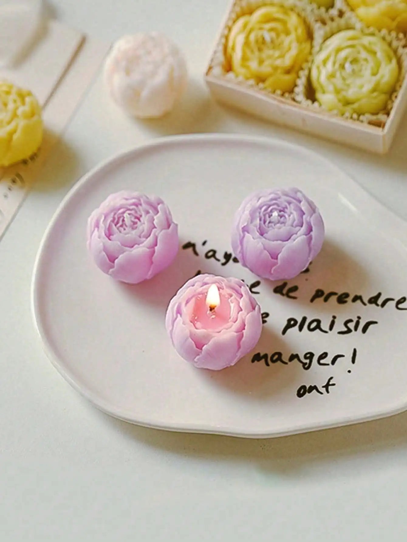 Floral candle set: lavender and pink rose tea lights on white plate, one lit