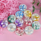 Assorted seashell scented candles in glass holders, starfish and shell decorations