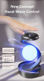 Hand-wave controlled floating lamp with bright blue glowing orb on dark gray base