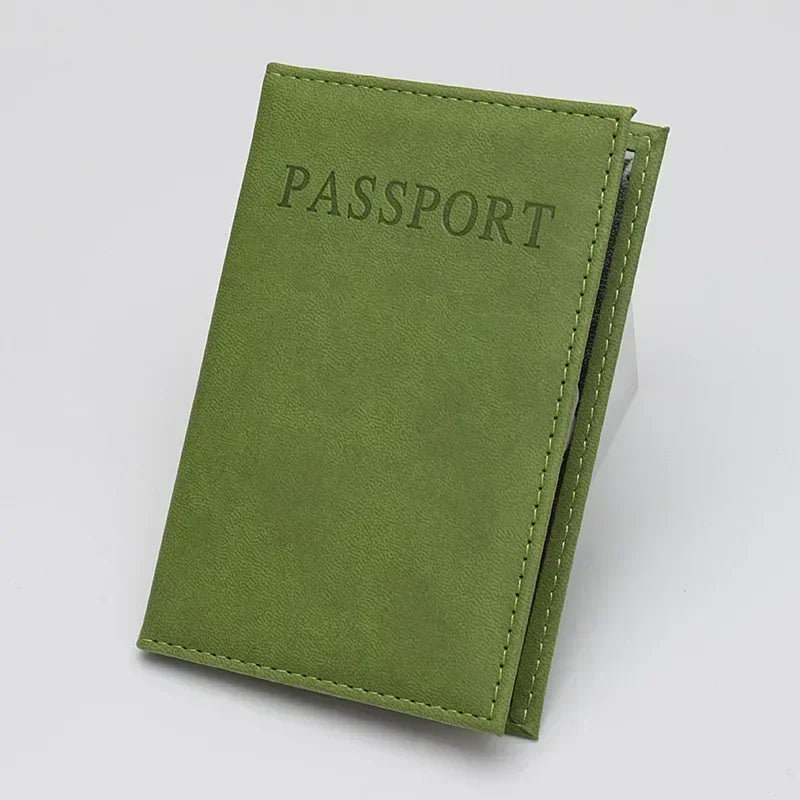 Sage green passport sleeve with embossed “PASSPORT” text and stitched edges