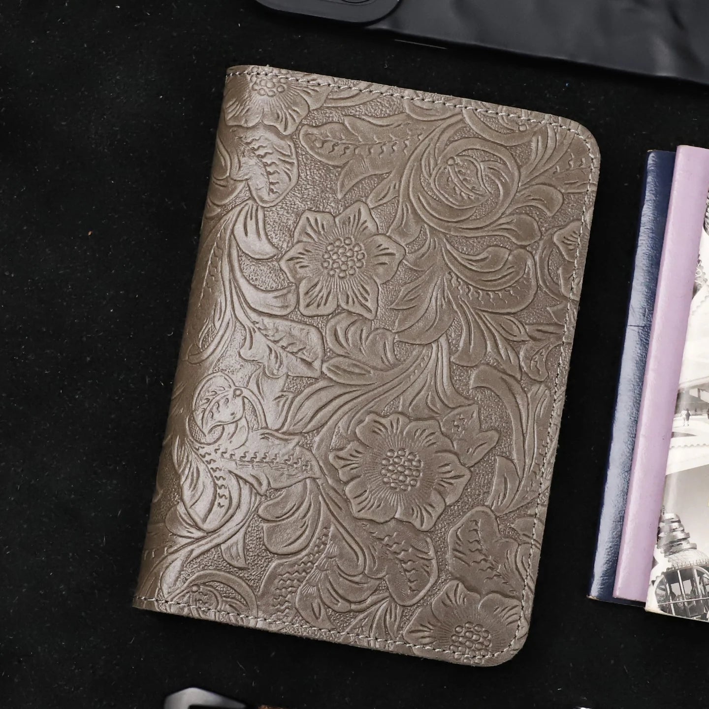 Gray leather travel folio with embossed floral pattern and stitched edges