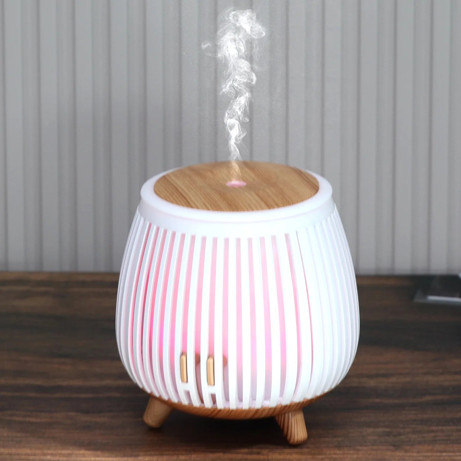 Ultrasonic aroma diffuser humidifier with wood-grain top, pink striped glow, misting