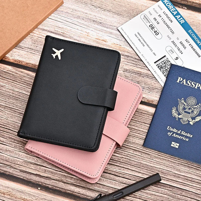 Black passport folio with airplane emblem and matching blush pink interior insert