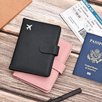 Black passport folio with airplane emblem and matching blush pink interior insert