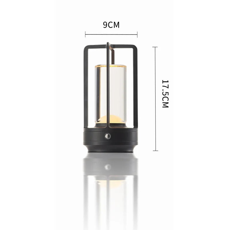 Lantern-style table reading lamp with rectangular frame, dark finish and warm glow