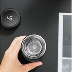 Black insulated thermos with open stainless lid and digital temperature display