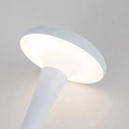 Pearl white cordless mushroom touch table lamp head glowing with soft, warm light.