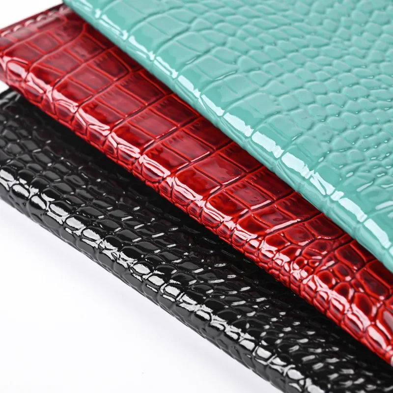 Close-up of croc-texture vegan leather: Burgundy, Forest Green, and Midnight Black