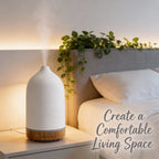 Ivory white ceramic oil diffuser with wood base and continuous mist stream