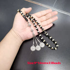 Prayer beads tasbih with black and gold striped beads and silver dangling medallion coins