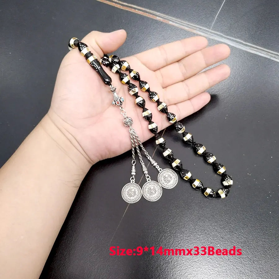 Prayer beads tasbih with black and gold striped beads and silver dangling medallion coins