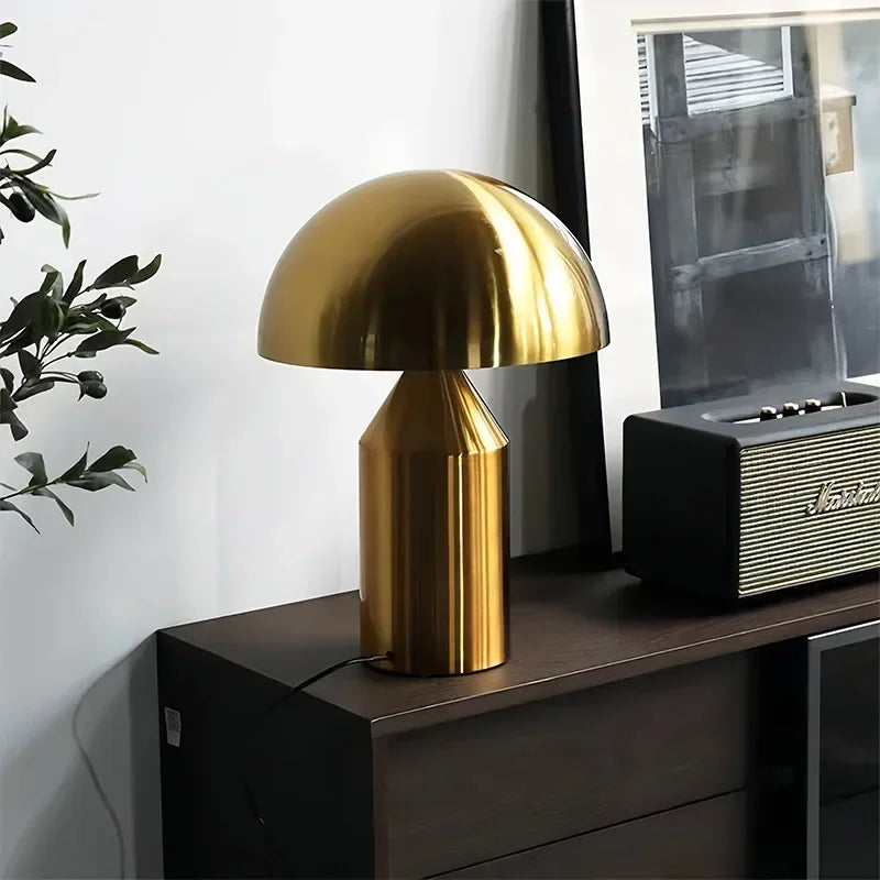 Gold mushroom LED table lamp with shiny gold dome and column base on console