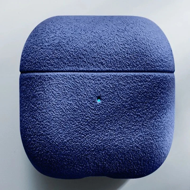 Italian suede AirPods case in Sapphire Blue, closed lid and charging-light pin