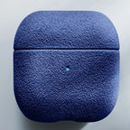 Italian suede AirPods case in Sapphire Blue, closed lid and charging-light pin