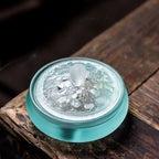 Cobalt glass incense vessel with embossed lid pattern and visible smoke