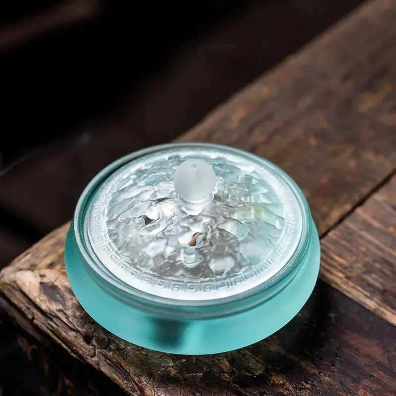 Cobalt glass incense vessel with embossed lid pattern and visible smoke
