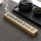 Bamboo incense box holder on table with geometric carved strip