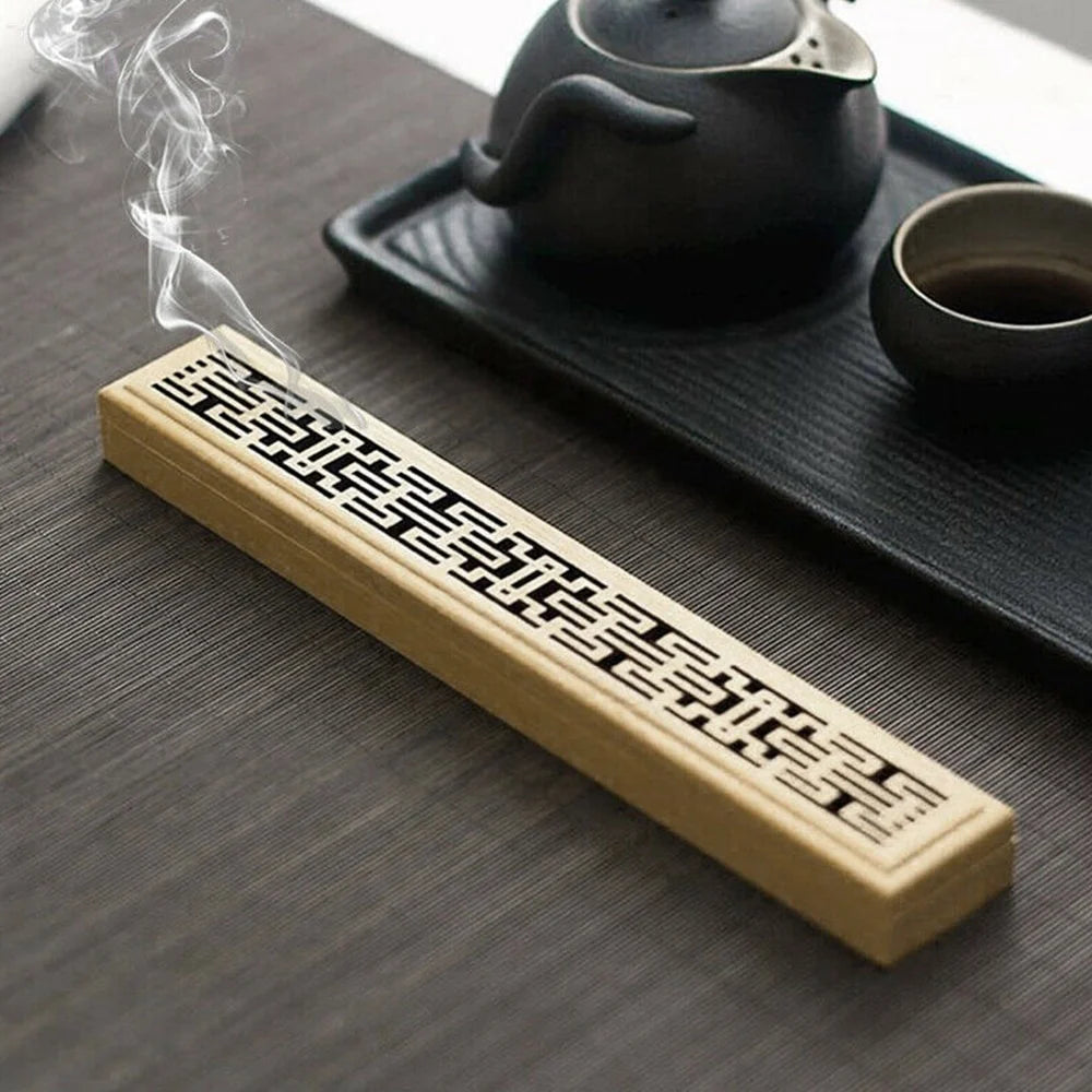 Bamboo incense box holder on table with geometric carved strip