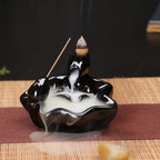 Glossy black backflow incense tower dish burner with cone incense and smoke plume