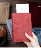 Cardinal Red embossed leather travel folio held with passport and cards behind
