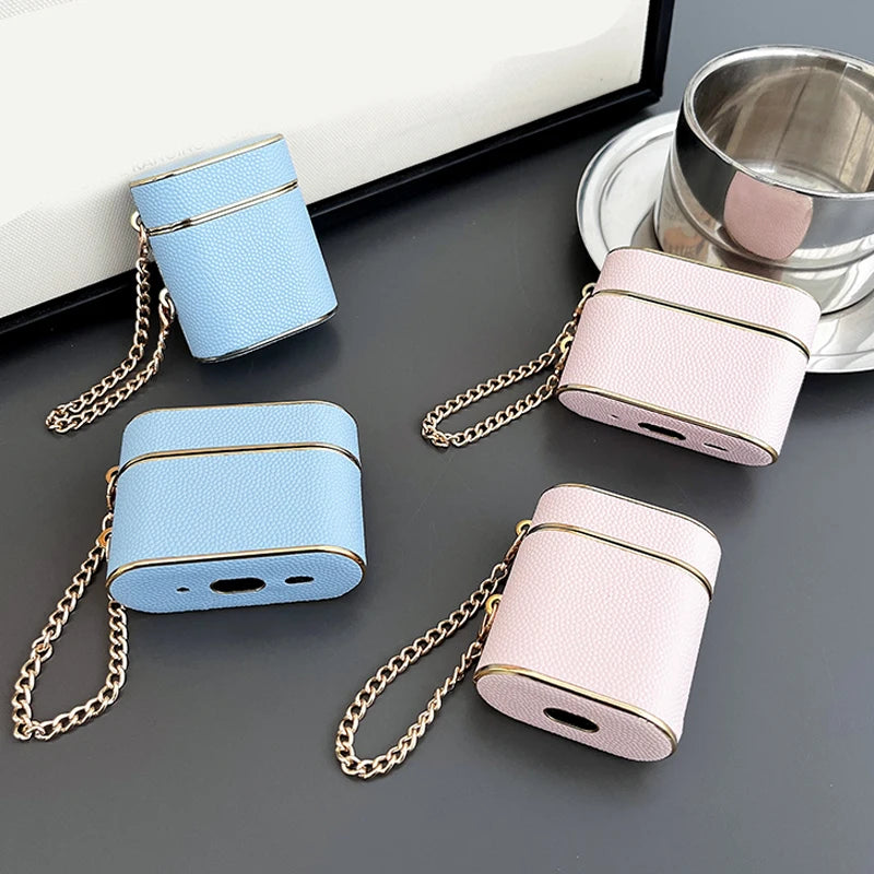 Wrist strap AirPods case set: light blue and rose blush with gold chain.
