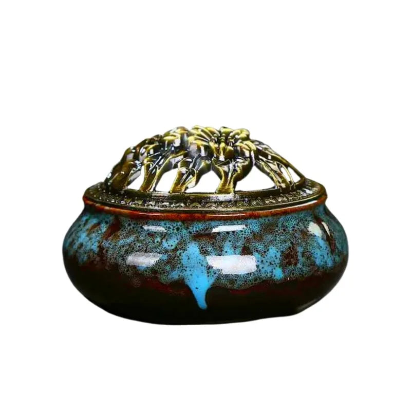 Ceramic incense burner with blue speckled glaze and ornate gold lid