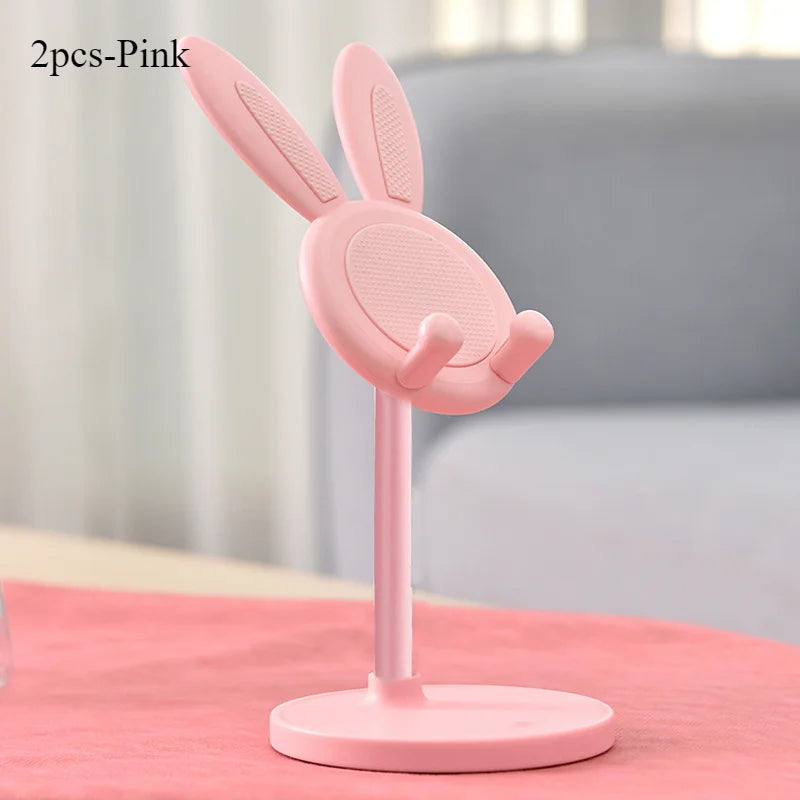 Blush pink rabbit phone stand with mesh ear panels, curved hands, and round base