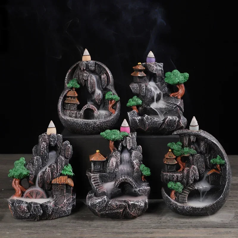 Resin landscape waterfall incense burner with green trees and orange-roof houses, purple incense cone