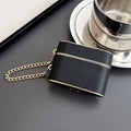 Obsidian (dark) wrist strap AirPods case with gold chain and gold trim.