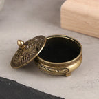 Engraved brass incense plate with dark insert and decorative hinged lid