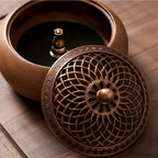 Round solid wood incense tray with metal lid and base insert visible from above