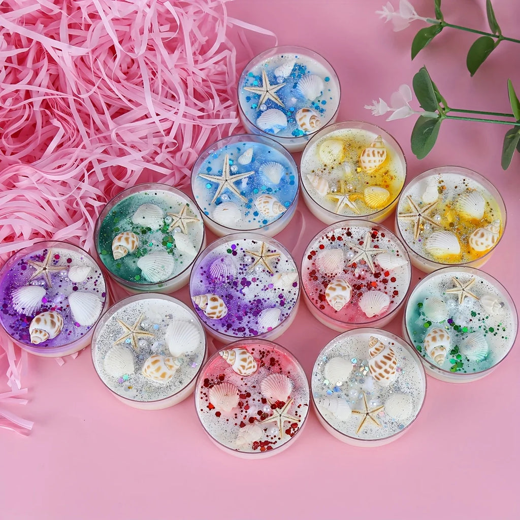 Top view of seashell-scented candles in glass cups, starfish and seashell decorations