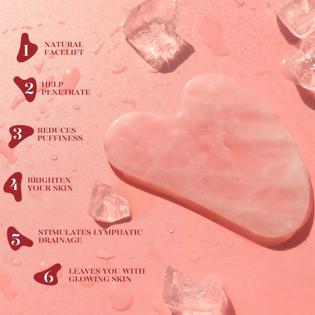 Pink gua sha heart tool and small roller pieces on textured surface