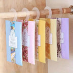 The Wardrobe & Car hanging sachet set, mix scents on white hangers