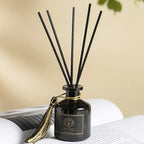 Hotel Reed Diffuser Set 50ml: dark glass bottle with black reeds and gold-tied cap