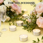 Tea light candles in silver metal cups, several lit with cream flames