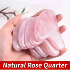 Pink jade gua sha tool fan set in hand, curved ridged scraping edges