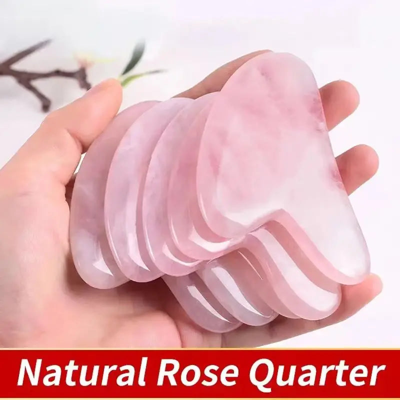 Pink jade gua sha tool fan set in hand, curved ridged scraping edges