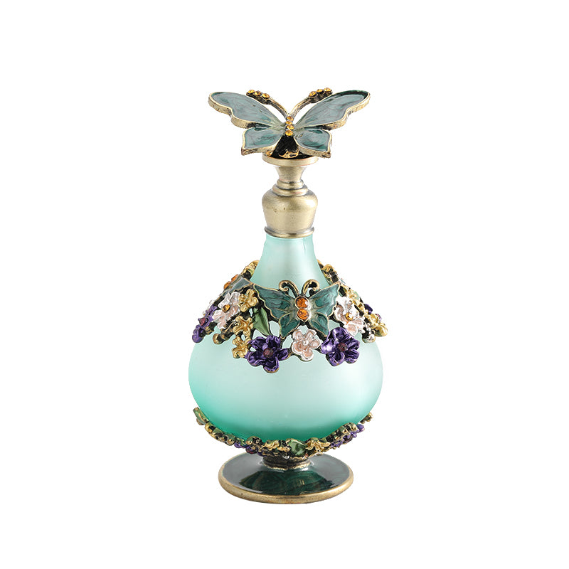 Butterfly perfume oil bottle with mint glass body, purple and gold floral accents, gold base