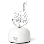 Aroma diffuser with white base and curved flame-like glass aroma outlet