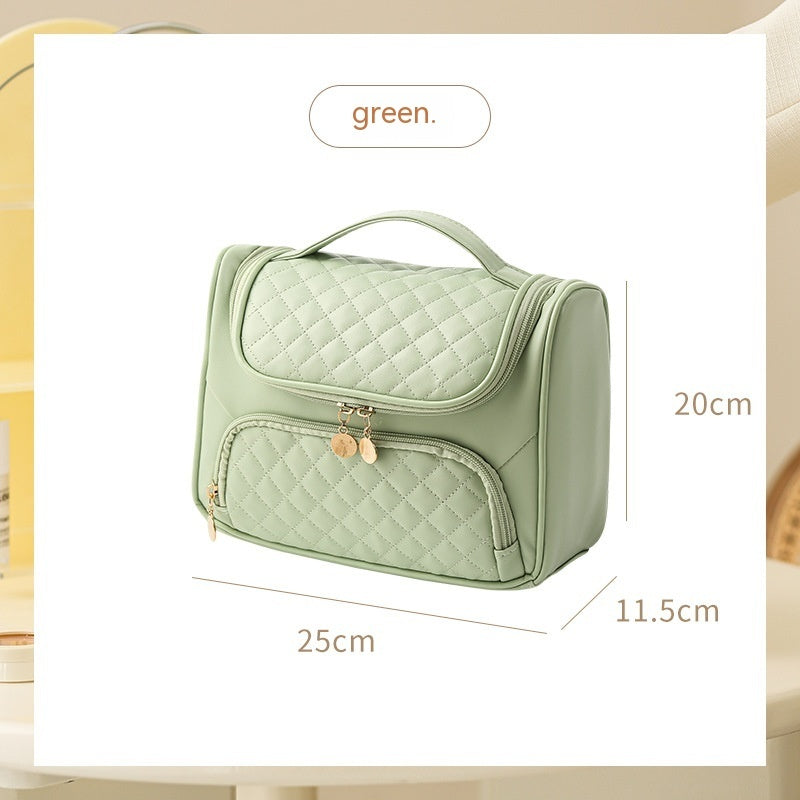 Fresh green vanity bag with quilted lid and front zip pouch, gold-tone zipper pulls