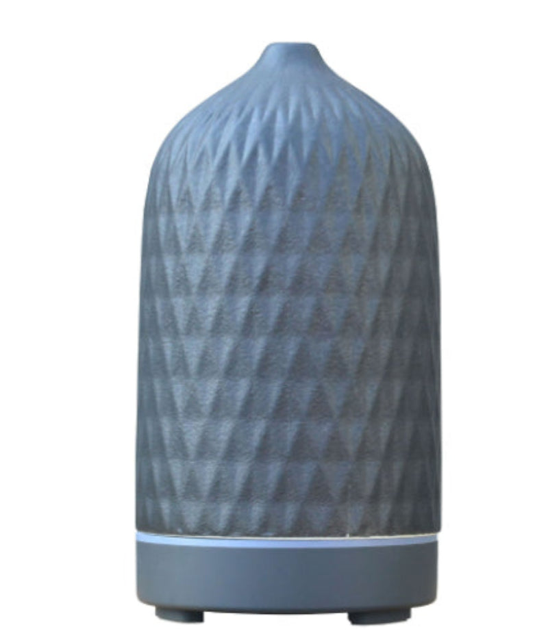 Textured blue ceramic aroma diffuser, geometric ribbed bottle with base and feet